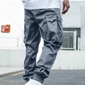 Detailed view of grey men's cargo pants featuring large side pockets and jogger cuffs.