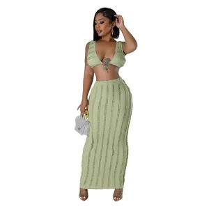 Full-body view of a stylish two-piece green textured skirt set with a sleeveless crop top