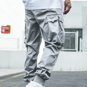Detailed view of grey multi-pocket cargo jogger pants highlighting the side pocket design