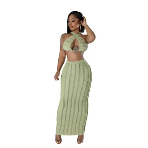 Full view of light green textured two-piece sleeveless crop top and maxi skirt set