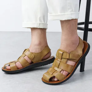 Close-up of men's brown Roman sandals with breathable woven design and soft sole.