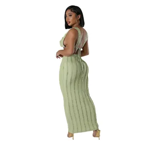 Detail view of green textured two-piece set featuring backless top and maxi skirt
