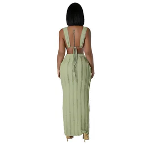 Detail back view of a textured green two-piece set with a tie-back crop top and maxi skirt