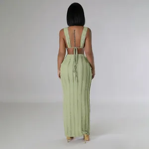Back view of sage green textured two-piece set with backless tie-up top and maxi skirt.