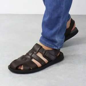 Detail view of men's brown Roman sandals with soft sole and breathable leather straps.