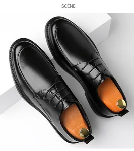 High-angle detail of black leather dress shoes showing textured finish and laces