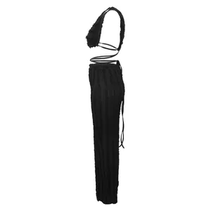 Profile view showing the intricate texture of this black lace halter top and pants set