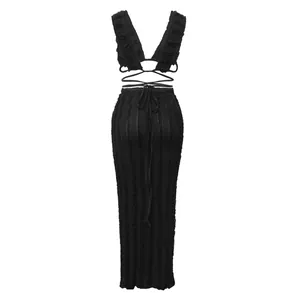 Detailed view of black textured lace sleeveless tie-back crop top and maxi skirt set.