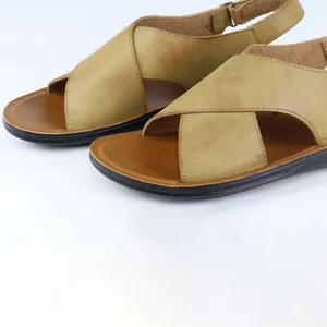 Close-up of men's Roman leather sandals with cross-strap design and soft sole.