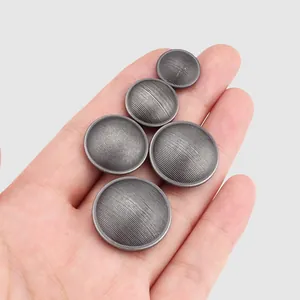 Set of five antique silver brass buttons with grooved texture for sewing on garments