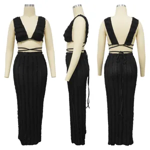 Detailed view of black two-piece lace set with tie-back crop top and maxi skirt