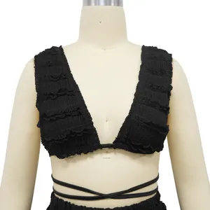 Close-up of black lace sleeveless top featuring ruffled texture and wrap-around ties