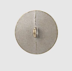 Close-up back view of a round vintage metal shank button designed for high-end garments