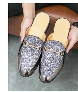 Close-up detail showing the sequined texture and golden buckle on men's loafers