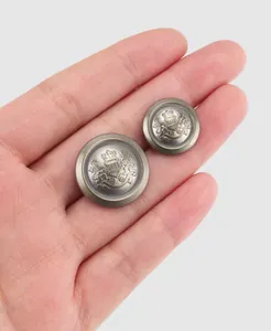 Close-up detail of premium antique bronze metal buttons with embossed royal crest design