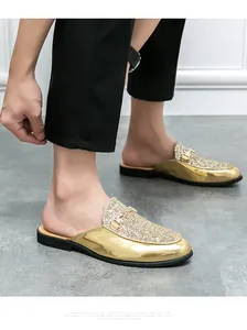 Close-up detail of gold metallic loafers with glitter and metal buckle.