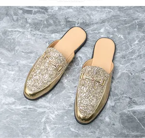 Close-up view of premium men's gold glitter mules featuring an elegant gold horsebit buckle