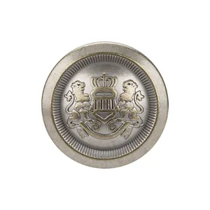 Vintage metal button with embossed royal lion and crown crest on white background
