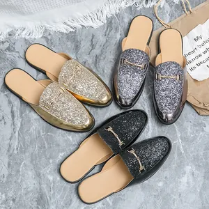 Fashionable men's glitter sequin mule loafers with metal buckle on marble background