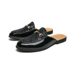 Black glitter and patent leather men's slip-on loafers with gold horsebit buckle.