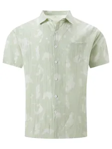 Detail view of men's light green tie-dye short-sleeved casual beach shirt with pocket