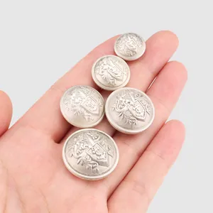 Set of vintage brass heraldic crest buttons for high-end custom suits and blazers.
