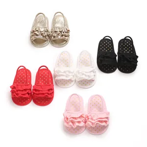 Detailed view of baby girls' ruffled sandals in gold, black, red, white, and pink.