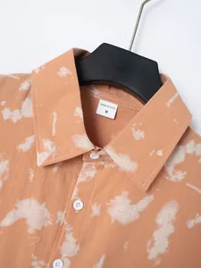 Detailed close-up of tie-dye men's short sleeve shirt collar and fabric texture
