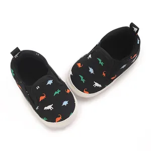 Close-up of baby boy soft sole walking shoes with colorful dinosaur patterns