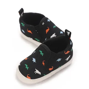 Detailed close-up view of black baby walking shoes with colorful dinosaur print patterns