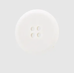 Detailed view of a matte white four-hole eco-friendly cotton button for linen apparel