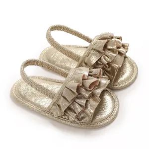 Detail view of golden baby girl sandals featuring elegant ruffle design and soft sole