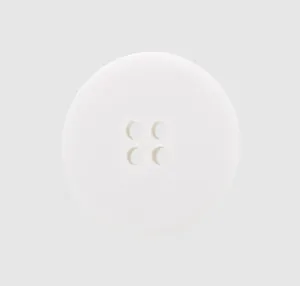 Detailed macro shot of a white eco-friendly four-hole cotton button for linen apparel
