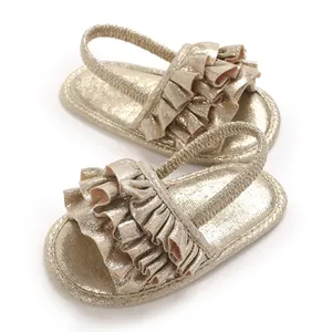 Gold ruffled soft sole walking sandals for baby girls with elastic heel strap.