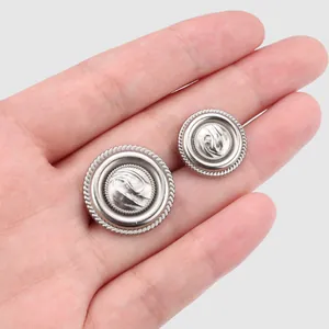Premium vintage silver textured metal buttons for high-end suits and coats shown on palm