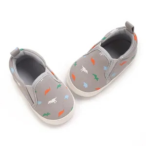 Grey canvas baby boy walking shoes with colorful dinosaur print patterns
