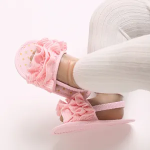 Close-up of pink ruffle baby girl walking shoes with soft sole and elastic strap
