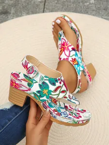 Nahaufnahme von sommerlichen, floral bestickten Zehentrenner-Sandalen mit Blockabsatz