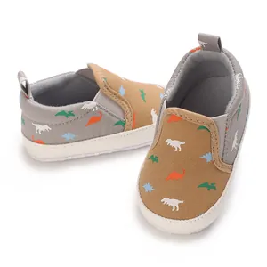 Detailed view of baby walking shoes with colorful dinosaur patterns and soft soles