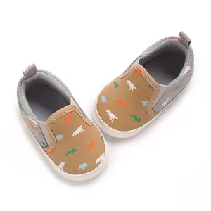 Detail view of khaki canvas baby walking shoes with colorful dinosaur patterns