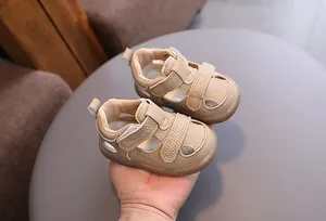 Detail view of beige breathable hollow sandals for babies featuring secure velcro straps