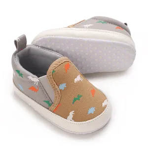 Detailed view of baby boy walking shoes with colorful dinosaur patterns and non-slip soft sole