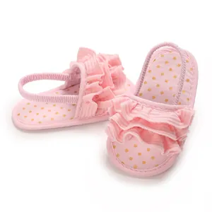 Detail view of pink baby pre-walker sandals with soft soles, ruffles and polka dot insoles
