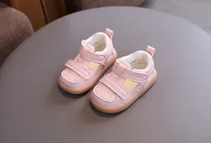 Detailed view of pink baby hollow breathable sandals with double hook-and-loop straps