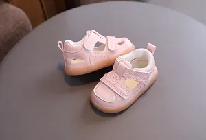 Detailed macro view of pink breathable baby sandals with functional velcro closures