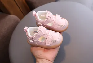 Detailed view of pink toddler hollow sandals with breathable design and velcro straps