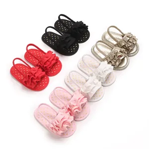 Variety of baby girls' ruffled sandals with polka dot insoles on white background