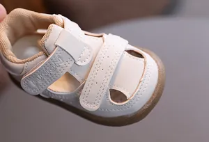 Detailed view of breathable beige baby sandals featuring secure velcro straps and a durable rubber sole