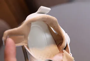 Close-up of soft mesh lining and breathable insole in white baby walking shoes