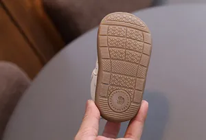 Macro view of the non-slip rubber sole on a vintage style baby walking shoe with size 16 130